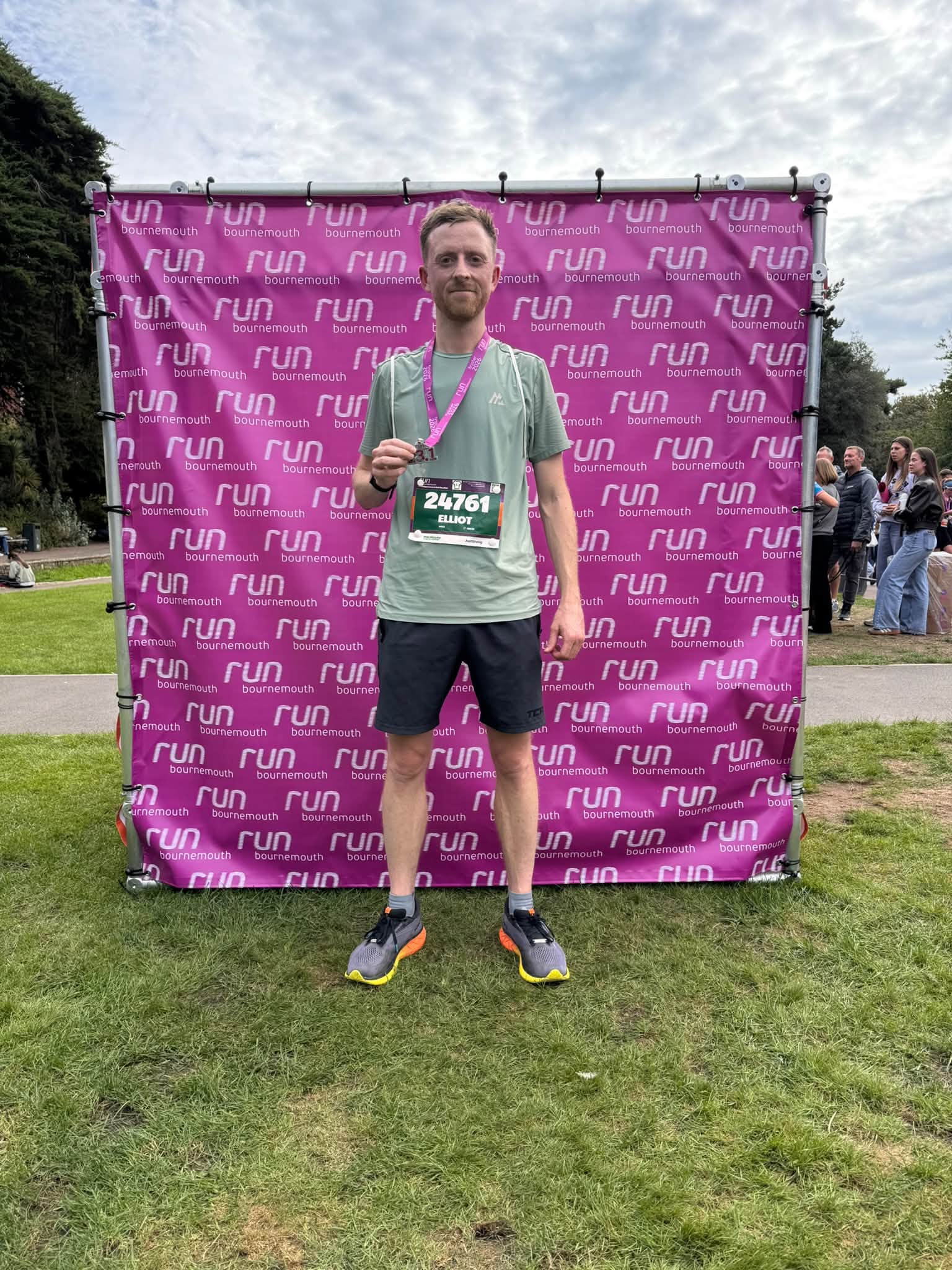 Elliot wearing his medal after completing the Bournemouth Half Marathon