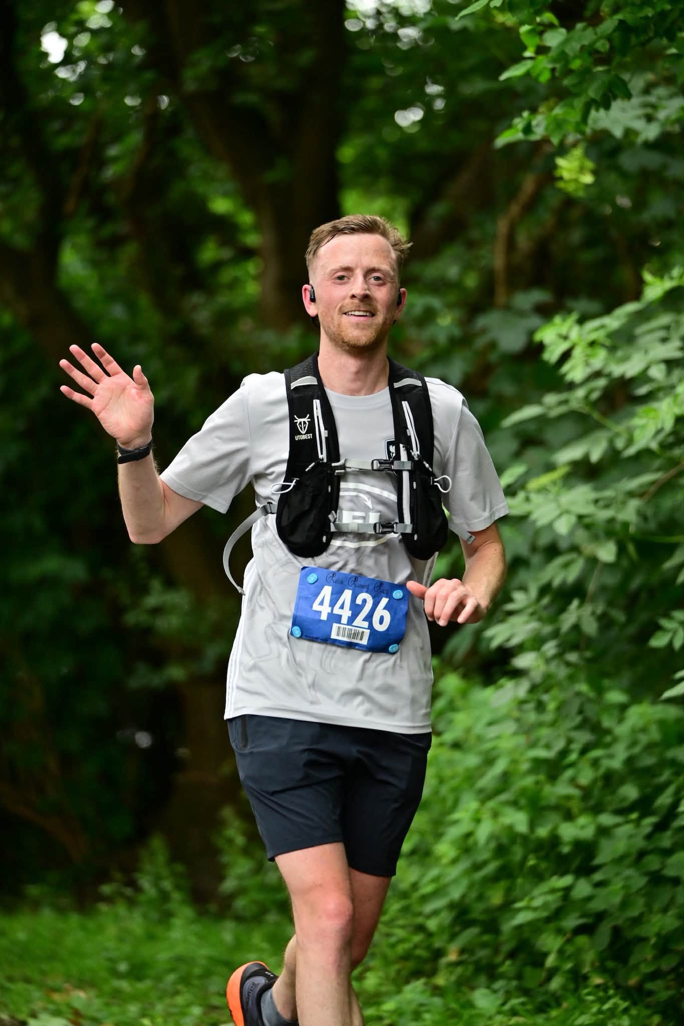 Elliot smiling and waving during the Bath Two Tunnels race